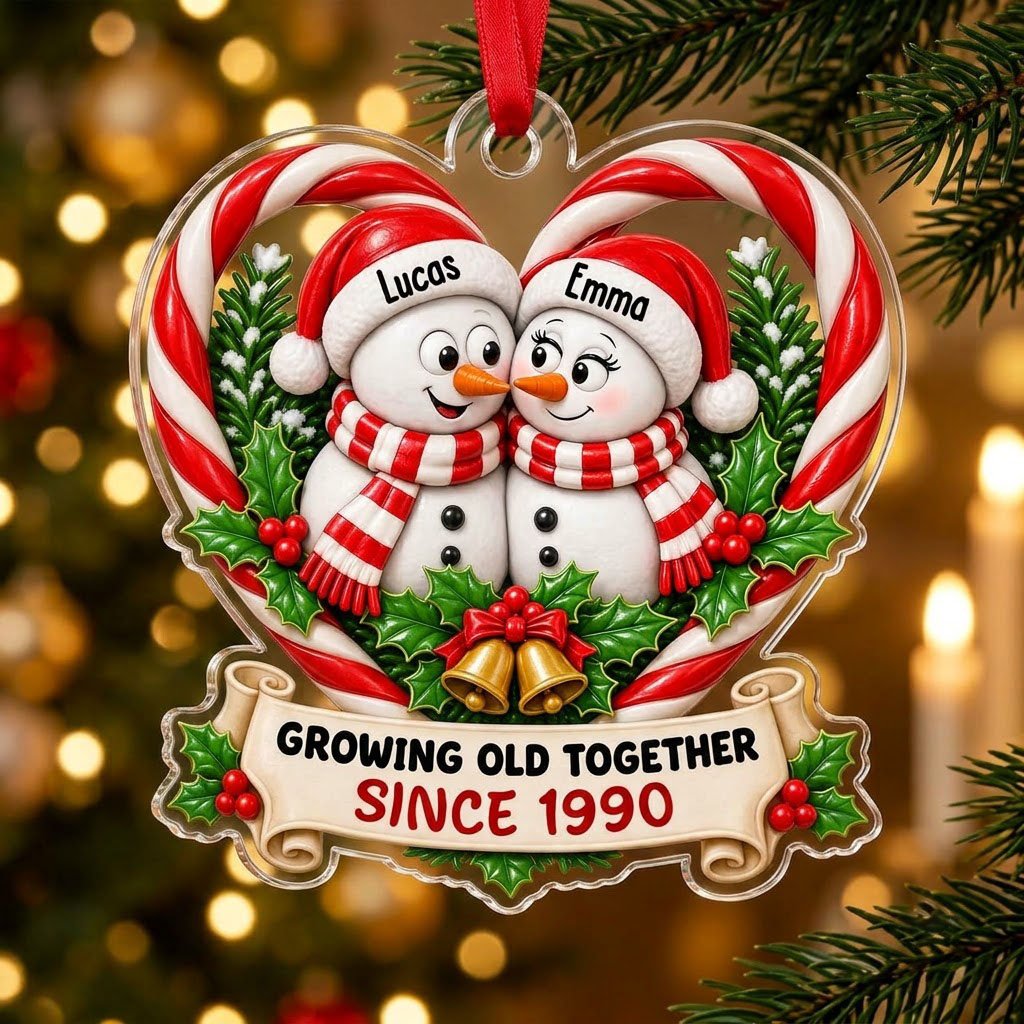 Two snowmen touching noses inside a candy-cane heart with holly, gold bells, and a scroll banner with names and year.