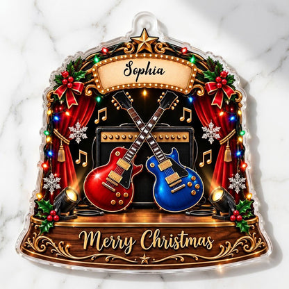 Custom-cut acrylic ornament with crossed red and blue guitars, Merry Christmas marquee, curtains and holly.