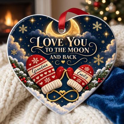 Heart ceramic ornament with golden crescent moon, red mittens, snowflakes and pine, personalized with two names.