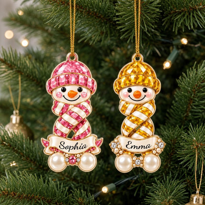 Custom-cut acrylic snowman ornament with jeweled hat and scarf, name banner, and faux pearl base.