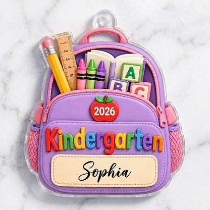 Purple backpack acrylic ornament with ABC blocks, apple, Kindergarten text, 2026 year, and a stitched name banner.