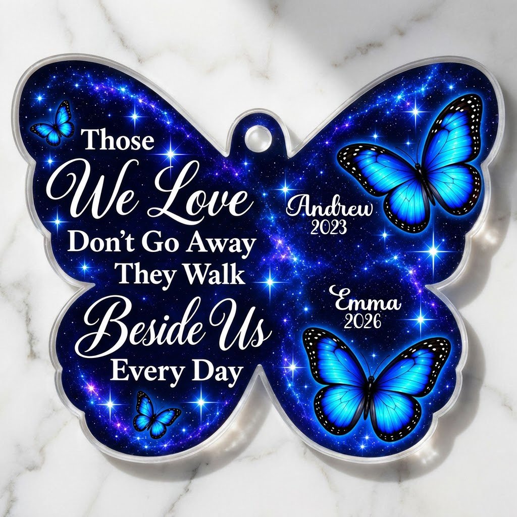 Butterfly-shaped ornament with blue butterflies and a galaxy background, reading Those We Love Don't Go Away.