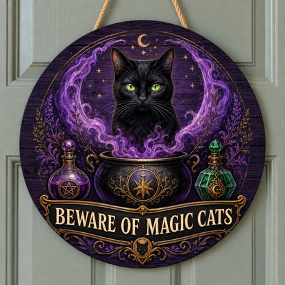 Round wooden sign with a black cat in purple smoke rising from a cauldron and the text BEWARE OF MAGIC CATS.
