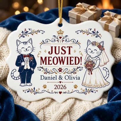 Medallion ceramic ornament with cat bride and groom, gold crown, floral scrolls, red hearts and paw prints on white.