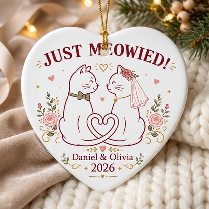 Two white cats with bow tie and bridal veil under JUST MEOWIED with roses and stars on a heart ceramic ornament.