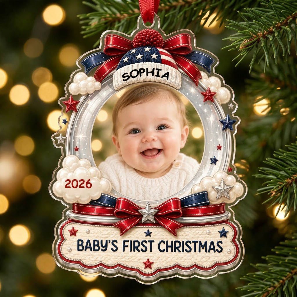 Custom-cut acrylic ornament with baby's photo, patriotic beanie, red bows, stars, and 'Baby's First Christmas' banner.