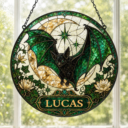 Round stained-glass style suncatcher with black bat, green wings, crescent moon, ivy, white flowers, and a personalized 