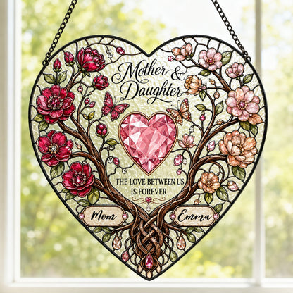 Heart-shaped stained-glass style suncatcher with intertwined trees, red and pink flowers, butterflies, and a pink gem he