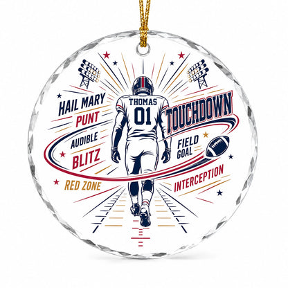 Round faceted glass ornament with football player back view, stadium lights, navy swoosh, and name and number.