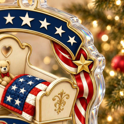 Acrylic ornament with baby crib, teddy bear, patriotic ribbon, and 'Baby's First Christmas', personalized with name and 