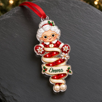 Clear acrylic ornaments shaped like a Christmas gnome and elf in red and green, each personalized with a name.