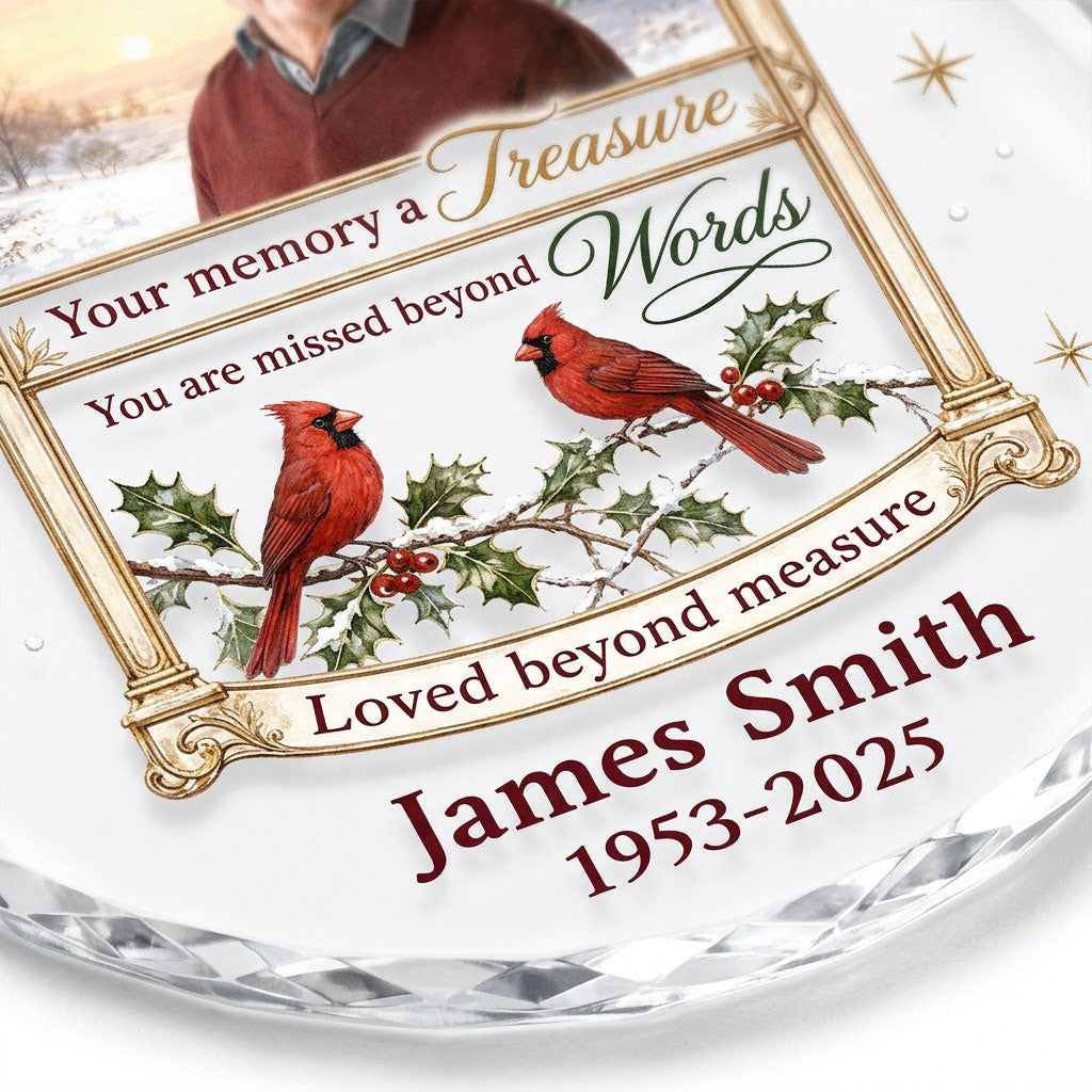 Round glass ornament with golden arched photo frame, two red cardinals on snowy pine and a memorial quote.