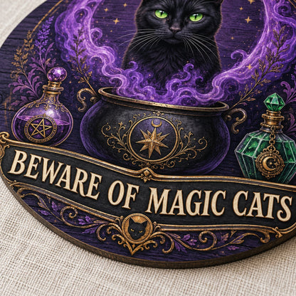 Round wooden sign with a black cat in purple smoke rising from a cauldron and the text BEWARE OF MAGIC CATS.