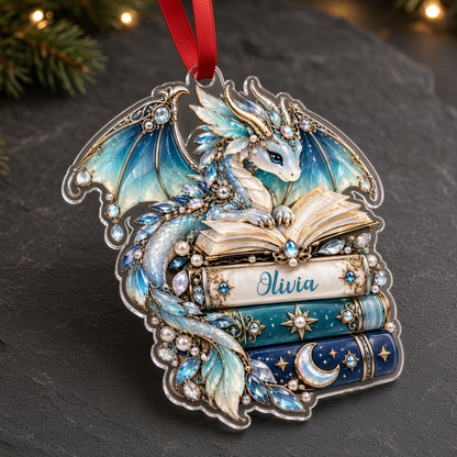 Custom-cut acrylic ornament of a jeweled blue dragon on stacked books with a red ribbon and a personalized name.