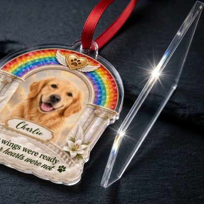 A rainbow arch pet memorial acrylic ornament with a winged golden heart, paw print, lilies, pillars, clouds and a photo 