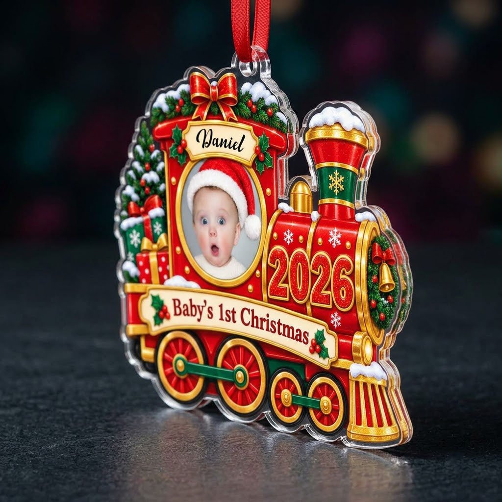 Red and gold train ornament with circular baby photo, bow, holly, wreath and 'Baby's 1st Christmas' on a scroll banner.