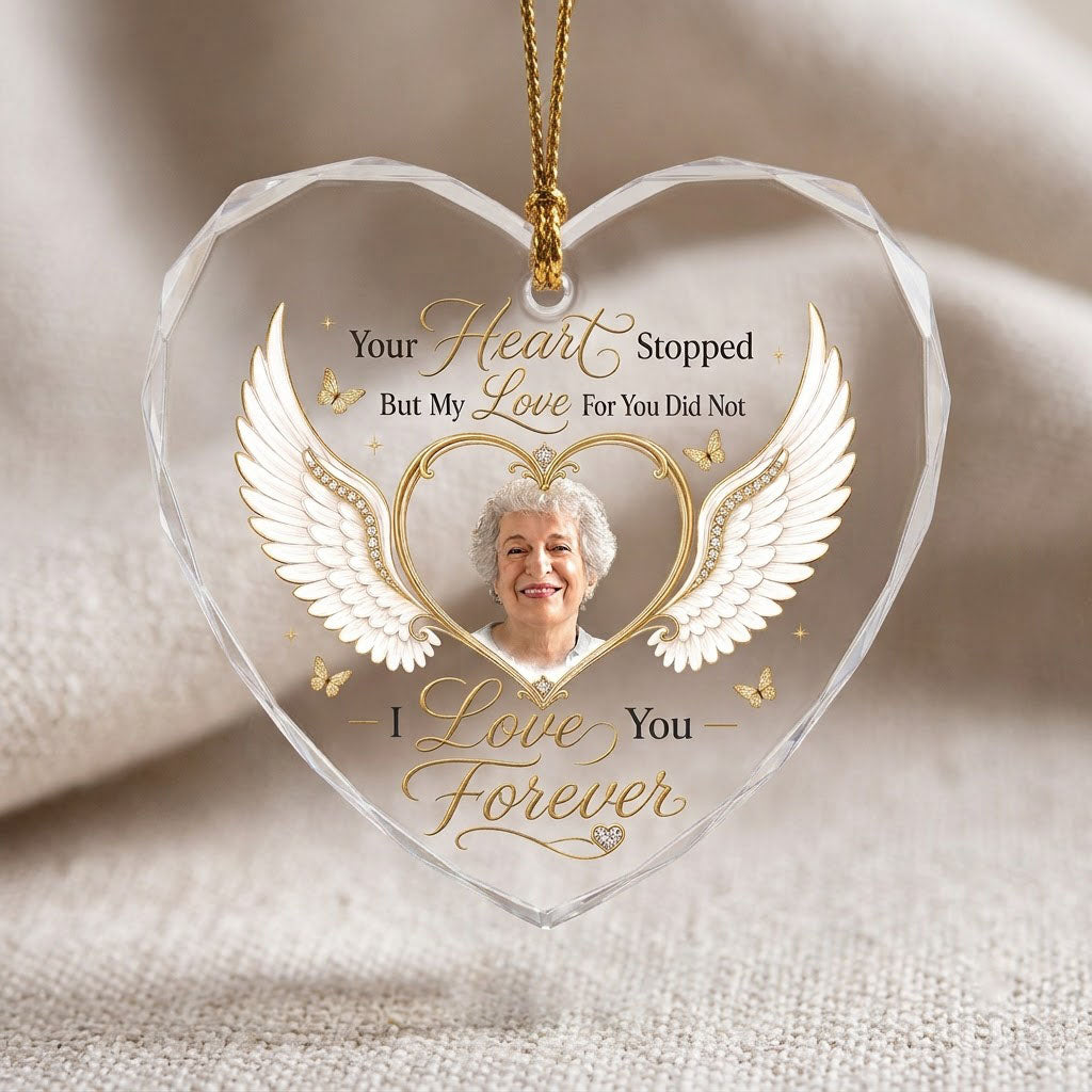 Heart-shaped glass ornament with white angel wings, gold heart photo frame, golden butterflies and sparkles.