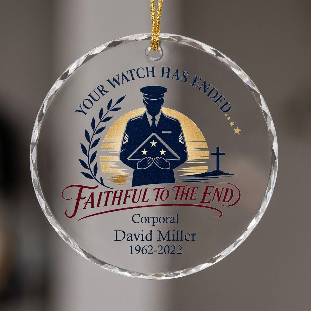 Round glass ornament with officer silhouette holding a folded flag, golden sunset, cross, and the words YOUR WATCH HAS E