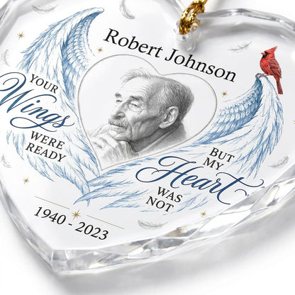 Heart-shaped glass ornament with blue angel wings, red cardinal, and a memorial quote with name and years.