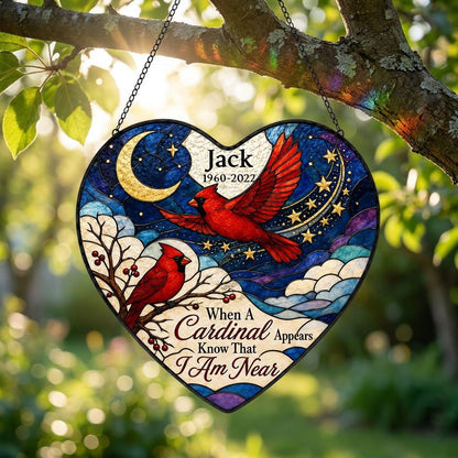 Heart stained-glass suncatcher with two red cardinals, a crescent moon, stars, and a branch with red berries.