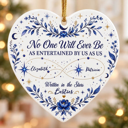 White heart ceramic ornament with blue florals, moons, stars, and “Written in the Stars Besties” with two names.