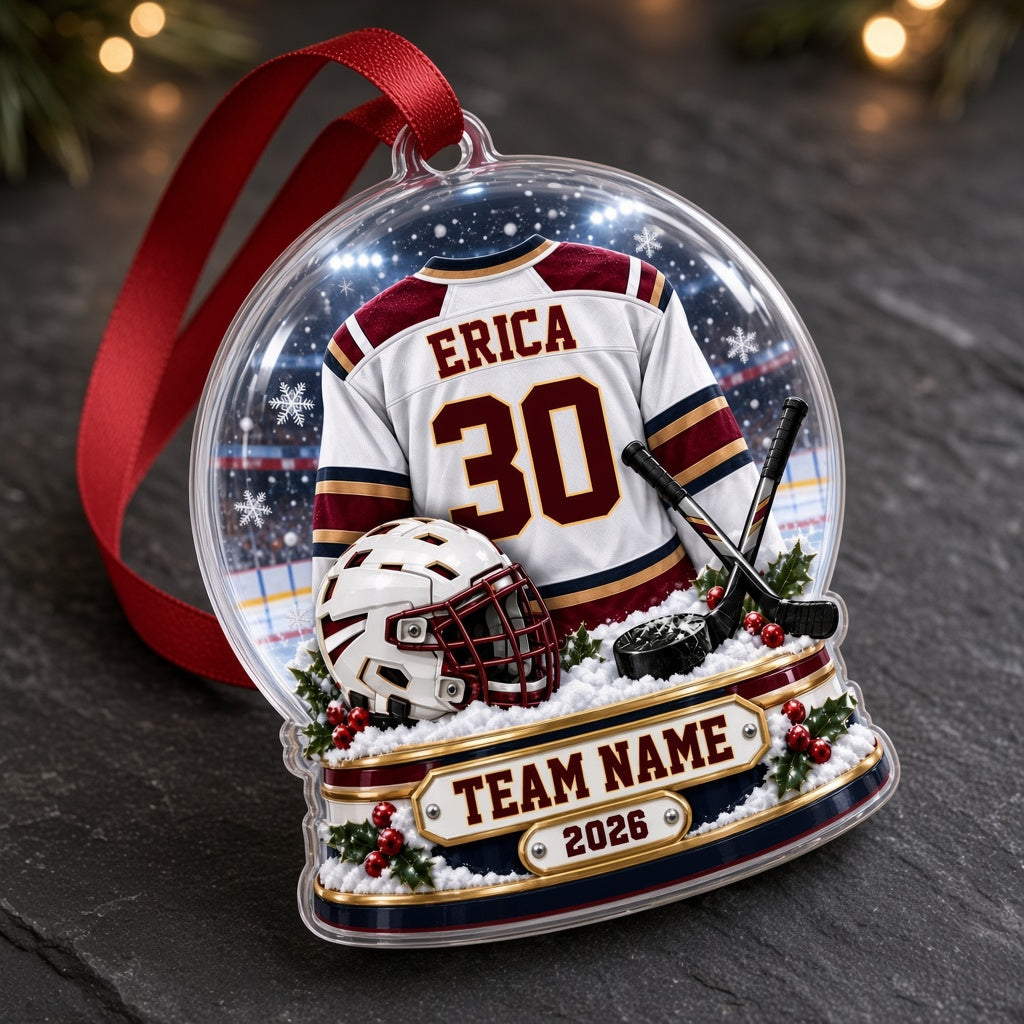 Acrylic snow globe ornament with hockey jersey, helmet, crossed sticks, puck, snowflakes and holly accents.