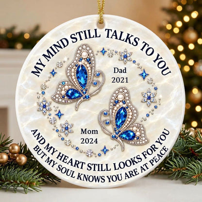 Round ceramic ornament with jeweled blue butterflies, floral rhinestones, and a cream marble background with memorial qu