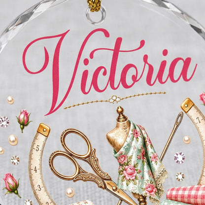 Round faceted glass ornament with a vintage dress form, sewing notions, and personalized name Victoria in pink and gold 