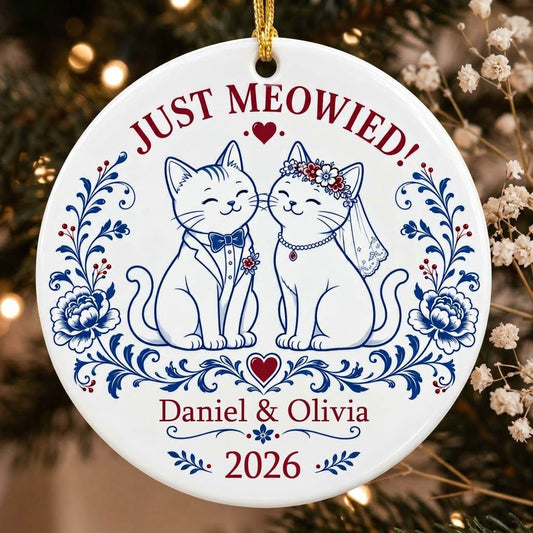 Round ceramic ornament with two wedding cats, 'JUST MEOWIED!', names and year with blue and red folk floral accents