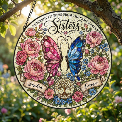 Round suncatcher with pink and blue butterfly, peony wreath, Tree of Life, and Sisters text with two name ribbons.