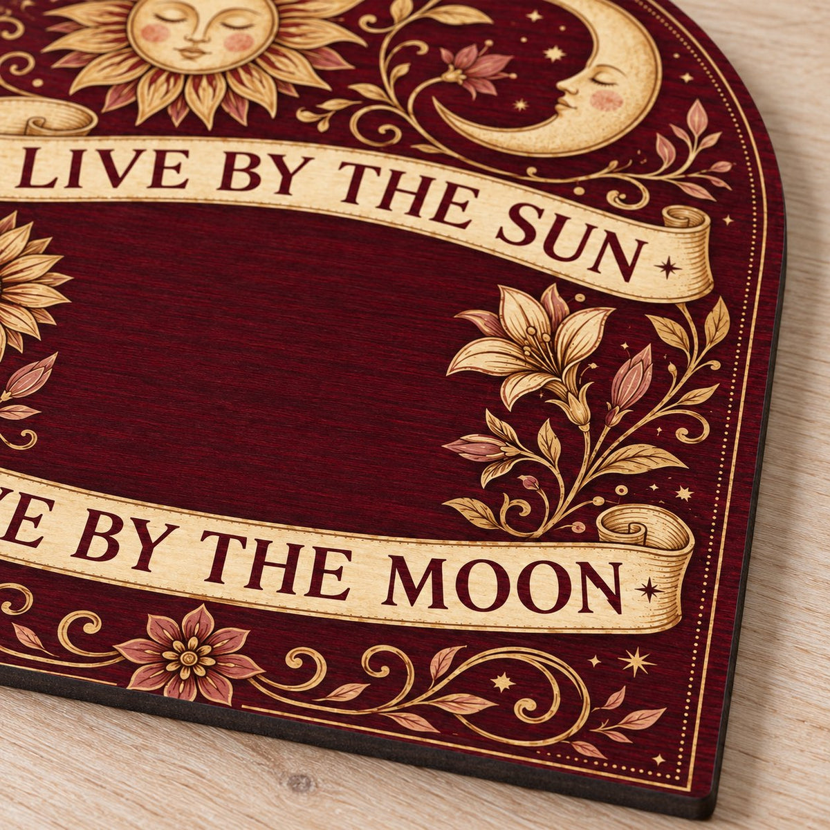 Arch sign with sleeping sun and moon, sunflower and lilies, banners reading Live by the Sun and Love by the Moon.