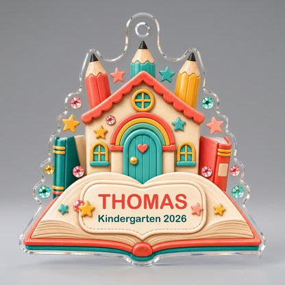 Clay-style schoolhouse on an open book with pencils and stars, personalized with child's name and Kindergarten 2026