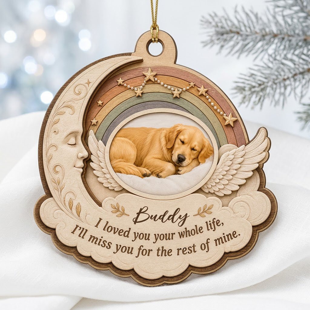 Wood ornament with crescent moon, angel wings, rainbow, and a sleeping dog photo above a cloud plaque.