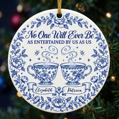Round white ceramic ornament with blue floral border and two teacups, personalized with two names