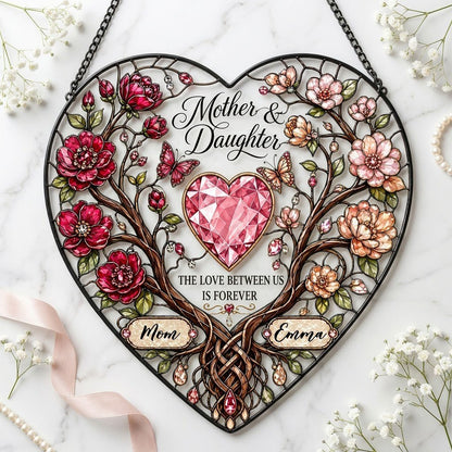 Heart-shaped stained-glass style suncatcher with intertwined trees, red and pink flowers, butterflies, and a pink gem he