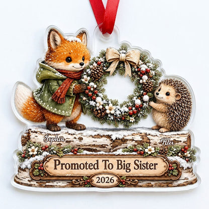 Acrylic ornament with a fox and hedgehog holding a wreath above a wood-style name banner with snowy accents.