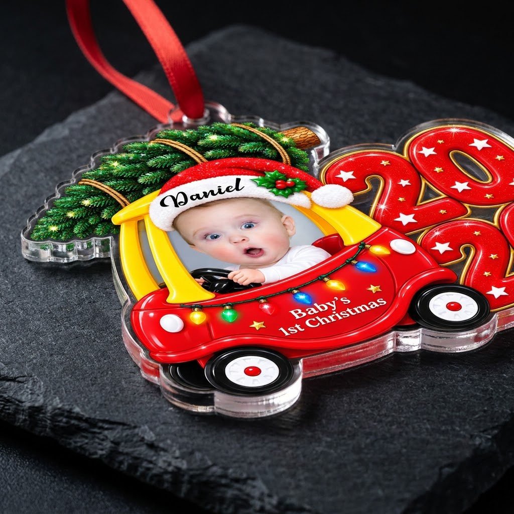 Acrylic ornament shaped like a toy car with tree, Baby's 1st Christmas text, lights, and a baby photo.