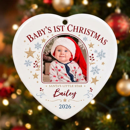 Heart ceramic ornament with arched photo frame, gold stars, blue snowflakes, holly, and 'Baby's 1st Christmas' text.