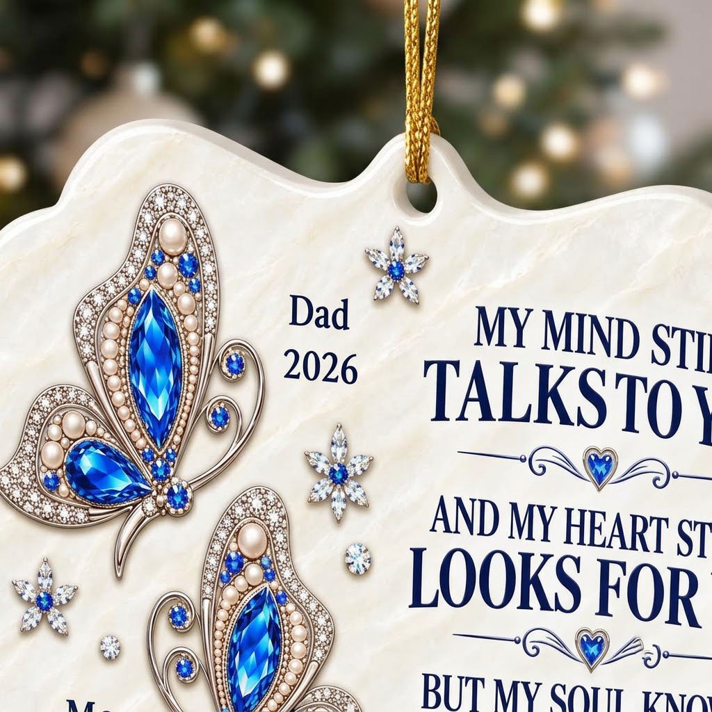 Scalloped ceramic ornament with two blue jeweled butterflies, silver starburst flowers and a memorial quote.