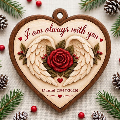 Heart-shaped wood ornament with angel wings around a red rose and the words 'I am always with you'.