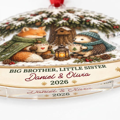 Acrylic ornament with snowy tree, fox and hedgehog holding mugs, banner says BIG BROTHER, LITTLE SISTER.