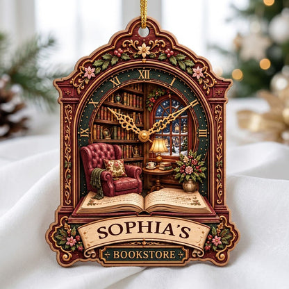 Ornate clock-shaped wood ornament with cozy bookstore scene, red armchair, bookshelves, arched window, and “BOOKSTORE” s