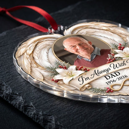 Heart-shaped acrylic ornament with angel wings, oval photo frame, white lilies, pine sprigs, red berries, and 'I'm Alway