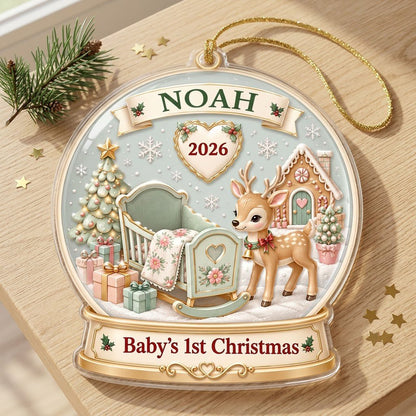 Acrylic snowglobe ornament with Baby's 1st Christmas, fawn with red bow, cradle, tree, gifts and gingerbread house