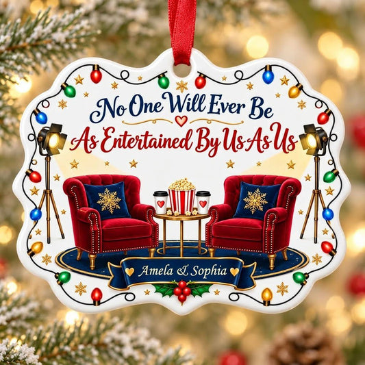 Ceramic ornament with lights, two red chairs, popcorn table, and 'No One Will Ever Be As Entertained By Us As Us'
