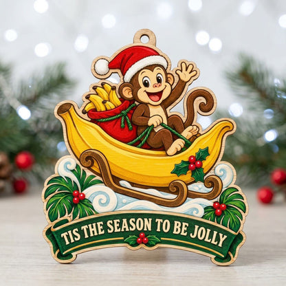 Custom-cut wood ornament with monkey in Santa hat riding a banana sleigh, banner reads TIS THE SEASON TO BE JOLLY.