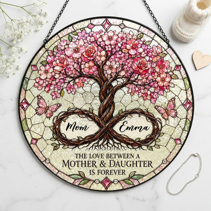 Round suncatcher with tree of life, pink blossoms, and 'THE LOVE BETWEEN A MOTHER & DAUGHTER IS FOREVER'