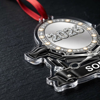 Clear acrylic ornament with a lit vanity mirror and salon tools, featuring SOPHIA and 2026 on a black banner.