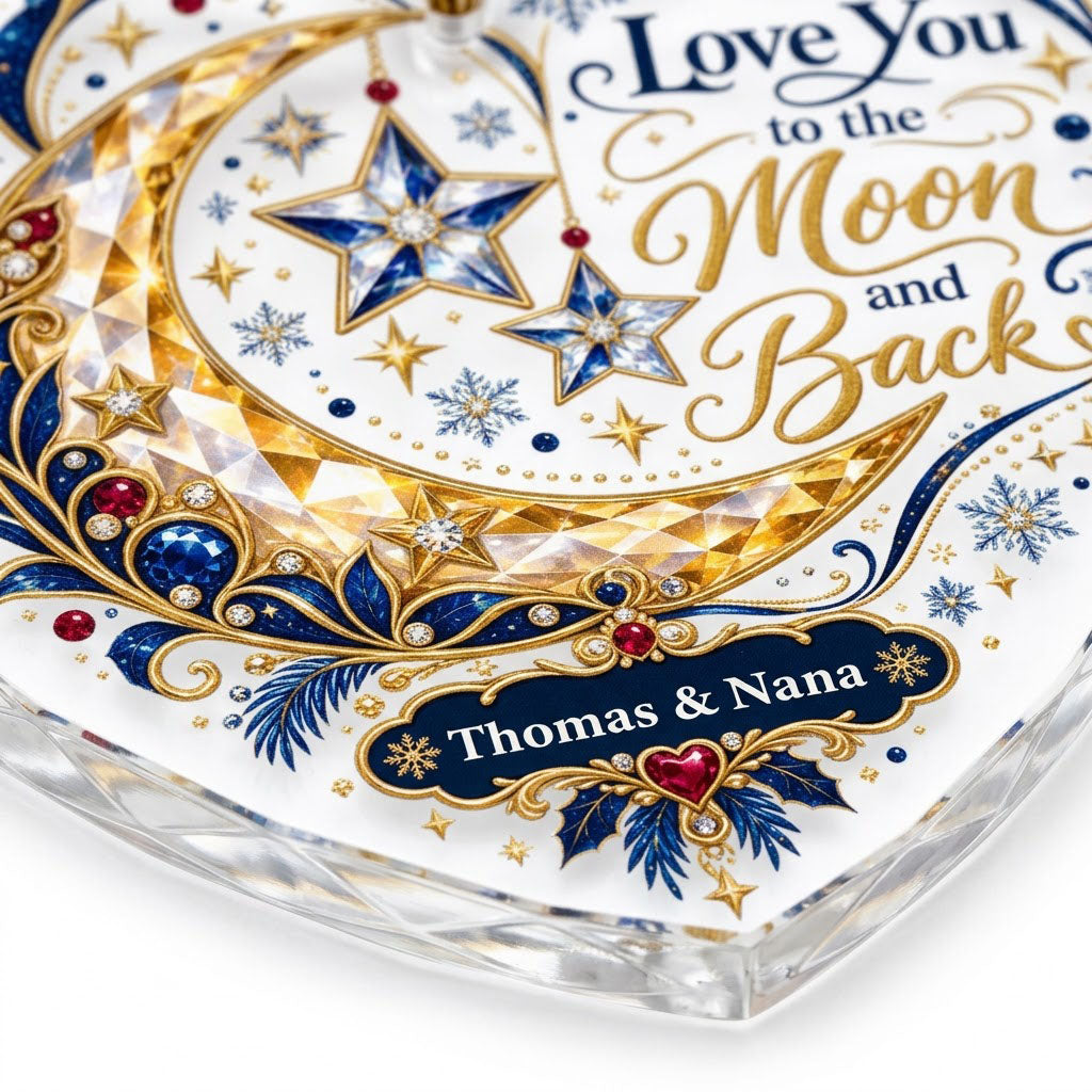 Heart glass ornament with jeweled gold crescent moon, blue hanging stars, and 'Love You to the Moon and Back' text.
