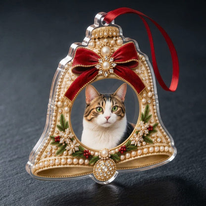 Bell-shaped acrylic ornament with red velvet bow, pearl and gold accents, and a central circular photo frame.